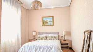 a bedroom with a bed with a white bedspread at Chalet en La Rioja para familias y grupos in Tricio