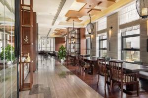 a dining room with a long table and chairs at SSAW Boutique Hotel Dexin Mogan Mountain in Deqing