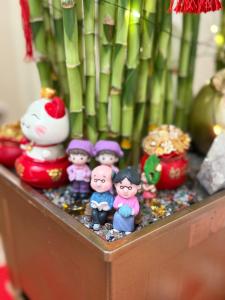 a group of toy figurines sitting in a planter at Jade Guesthouse Jonker Street Melaka in Malacca