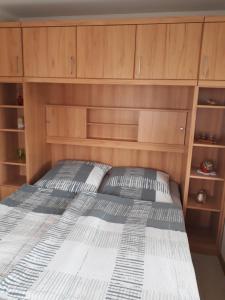 a bedroom with a bed with wooden cabinets at Ferienwohnung Arthur in Luckenwalde