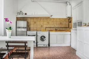 a kitchen with white cabinets and a washer and dryer at Casa Dolce Vita in Pigna +16 photos