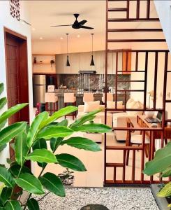 a kitchen and living room with a table and chairs at Parama Swaha Villa Near Canggu in Munggu