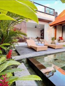 a villa with a pool and a house at Parama Swaha Villa Near Canggu in Munggu