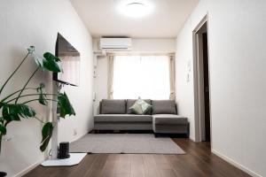a living room with a couch and a window at 新築Sunbright Asakusa 101 in Tokyo