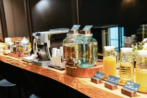 a counter with jars of drinks and a toaster at Aso Hotel in Aso