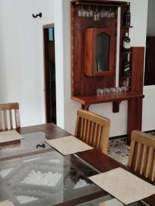 a dining room with a table and chairs and a mirror at Green View in Ambalangoda