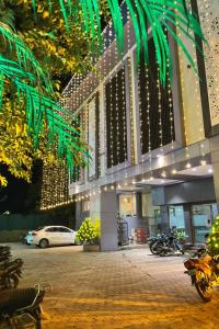 a car parked in front of a building with lights at Hotel Shree Abhishek in Bārāmati