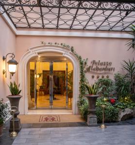 an entrance to a building with an archway at Palazzo Alabardieri in Naples