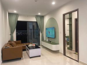 a living room with a couch and a tv at Rạng homestay in Quy Nhon