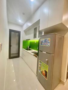 a kitchen with a stainless steel refrigerator and a sink at Rạng homestay in Quy Nhon