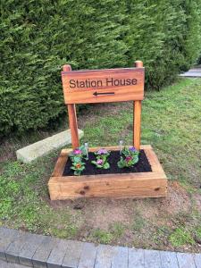 a station house sign with flowers in a wooden box at Station House in Sleaford