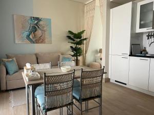a living room with a table and chairs and a couch at Oriole Havana Salalah in Salalah
