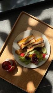a plate with a sandwich and a salad on a tray at 沐蘭精品旅館-台北大直館 Mulan Boutique Hotel in Taipei