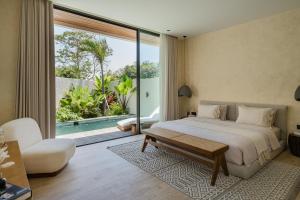 a bedroom with a large bed and a large window at Kono Villas & Resort in Ungasan +141 photos