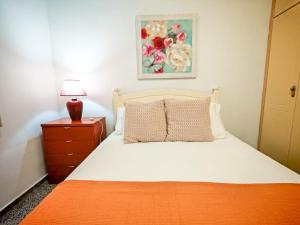 a bedroom with a bed and a lamp on a nightstand at Finca Hoya del Pino in Arafo