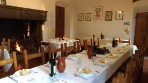 a dining room with white tables and a fireplace at Casa per la Pace in Impruneta +36 photos