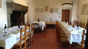 a dining room with tables with white tablecloths at Casa per la Pace in Impruneta