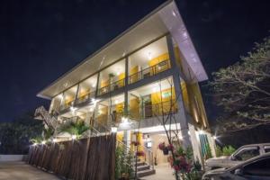 a building with a balcony with lights on it at รีสอร์ทที่ลำปาง (Resort At Lampang) in Lampang