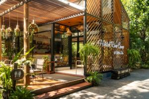 a house with a patio with plants in front of it at Hintok River Camp in Sai Yok +43 photos