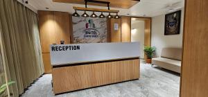 a reception desk in a lobby with a reception counter at Hotel Earth Orbit in Gandhinagar