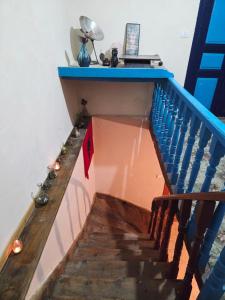 a stairway with a blue railing and a blue rail at Business Hostel in Korçë