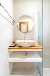 a bathroom with a sink and a mirror at Srikrisna in Seminyak