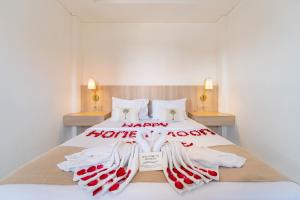 a bed with red and white towels on it at Srikrisna in Seminyak