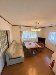 a living room with a couch and a table at 丸亀 Sawau 丸亀駅まで徒歩8分 うどん屋まで徒歩1分 5名まで宿泊可駐車場 1台有 港近 in Marugame