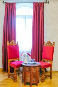 two chairs and a table in front of a window at Casa Natalia in Sinaia