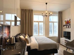 a bedroom with a bed in a room with windows at Orange Apartments Mere in Tallinn