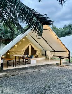 a large tent with a table and chairs at khaolakcamping in Ban Lam Ru (1)