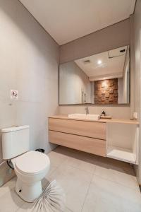 a bathroom with a toilet and a sink and a mirror at The Hita Apartement in Seminyak +59 photos