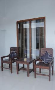 two chairs and a table with pillows on them at Sawe Homestay in Kuta Lombok