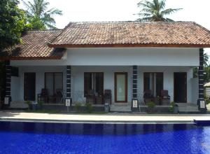 a house with a pool in front of it at Sawe Homestay in Kuta Lombok +50 photos