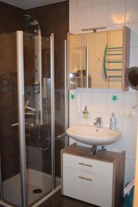 a bathroom with a sink and a shower at Allgäuschönheit inkl BadHindelangPlus Karte in Bad Hindelang +19 photos