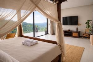 a bedroom with a bed with a large window at Exclusive Luxury 3-Bedroom Jungle Villa with Private Infinity Pool, Breathtaking Sea View & Peaceful Nature Escape in Mae Nam +48 photos