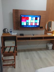 a living room with a television on a wooden table at Coral Bay King Studio in Khor Fakkan