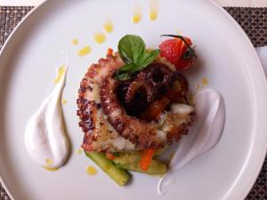 a plate of food with shrimp and vegetables on it at Villa Ghetta Country House in Leverano