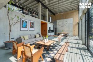 a living room with a couch and a table at StayVista at Matchbox with Pet-Friendly, BBQ & Lawn in Hosūr