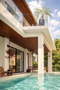 an external view of a house with a swimming pool at Exclusive Luxury 3-Bedroom Jungle Villa with Private Infinity Pool, Breathtaking Sea View & Peaceful Nature Escape in Mae Nam