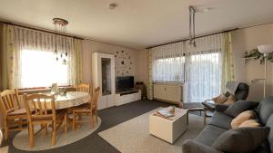 a living room with a couch and a table at Ferienwohnung Auszeit Erika 1 in Burhave