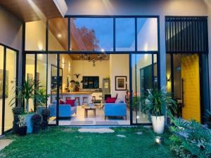 a house with large glass windows and a living room at OYO 1177 The Great Molave in Tagaytay
