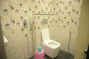 a bathroom with a white toilet in a room at hotel NemiResidency in Jagdalpur +26 photos