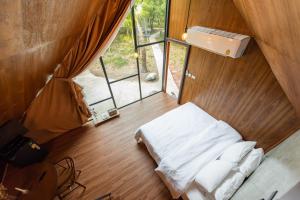 a small room with a bed and a window at Issara Bar&House in Ko Larn +178 photos