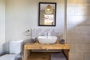 a bathroom with a sink and a toilet at Myrtle Forest Retreat Cabin in Plettenberg Bay