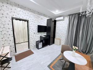 a living room with a table and a tv at Easyhome in Brazzaville