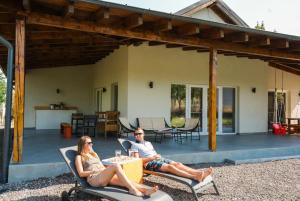 a man and woman sitting in chairs on a patio at Off-Site Stay in Cerghid