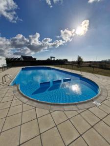 a large blue swimming pool on a patio at Nieuwendamme 69 with pool and parking in Nieuwpoort