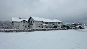 a house is covered in snow in a yard at Milincic‘s 2 Zimmerwohnung in Banja Luka