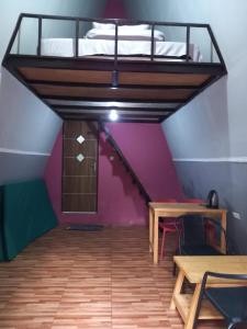 a room with a loft with a bed and a table at The Nest Park in Prigen +15 photos